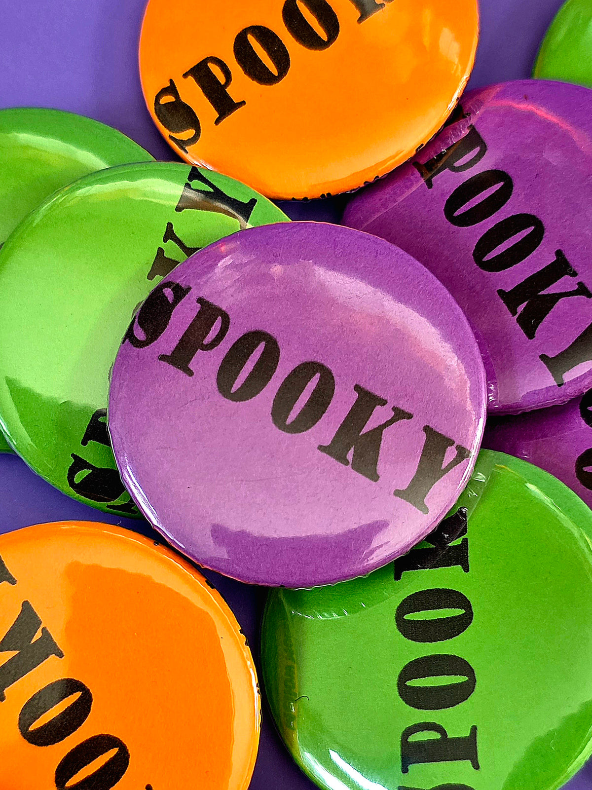 a purple button that says spooky