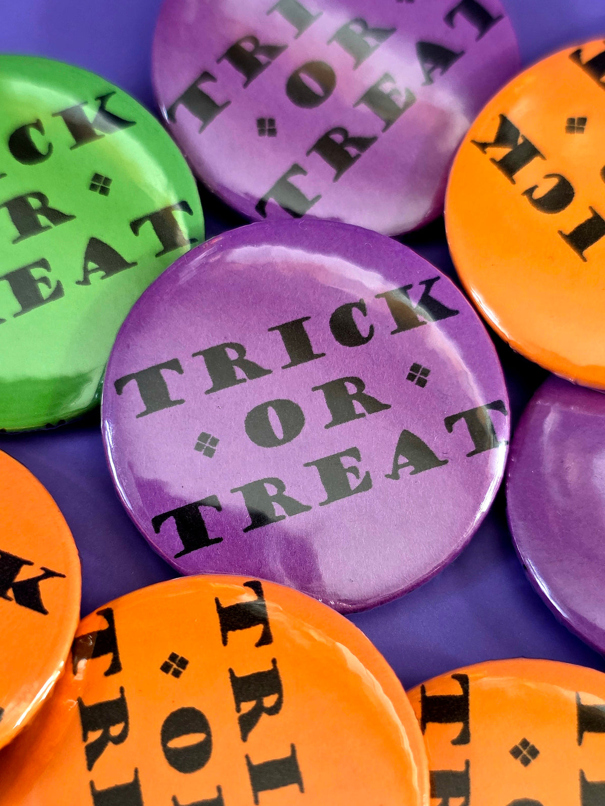 a purple button that that says "trick or treat"