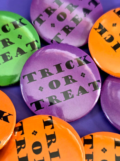 a purple button that that says "trick or treat"